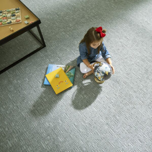 Child with story books on carpet